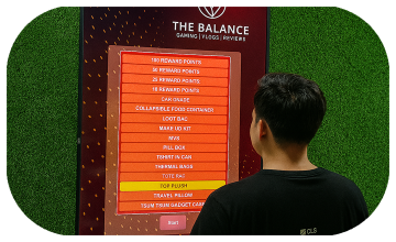 Guest playing interactive event game at exhibition booth in Dubai, pressing button to win prize, with branded screen display and selfie sharing feature for engagement.